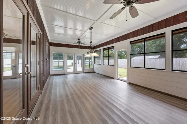 a view of interior space with wooden floor and fan