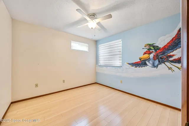 a view of a house with backyard and trees