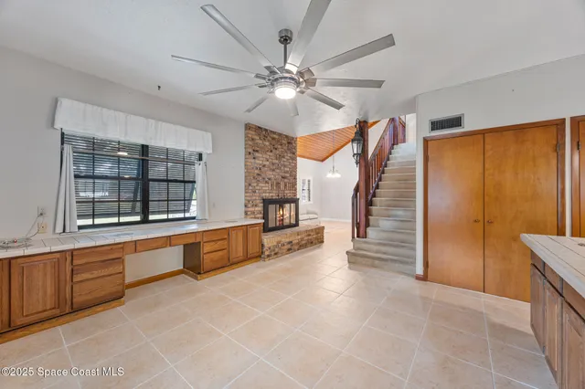 a large white kitchen with a large window