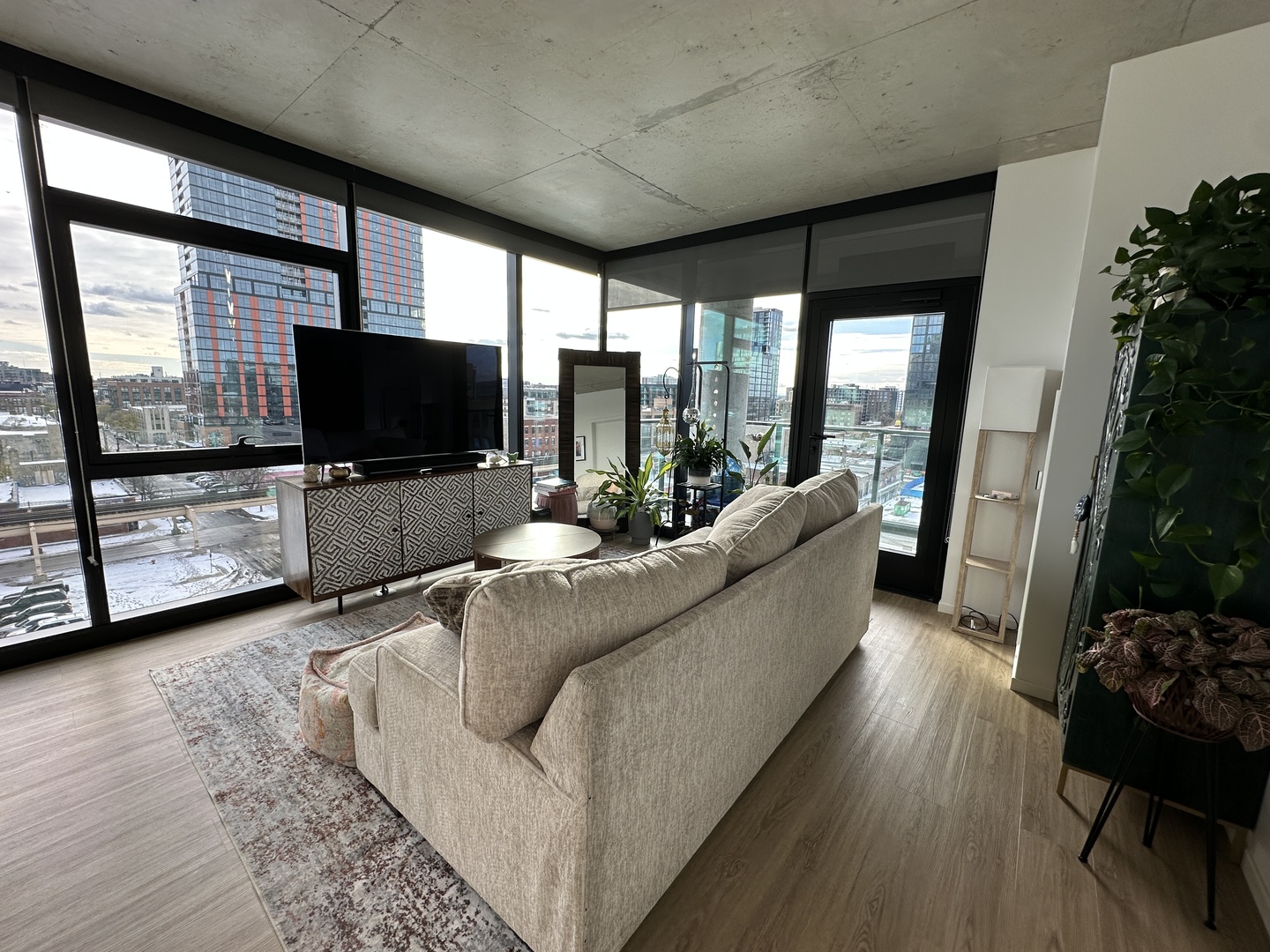 225 North Elizabeth Street, Unit 709 Chicago, IL 60607 - Photo 3 of 31 a living room with furniture and a flat screen tv