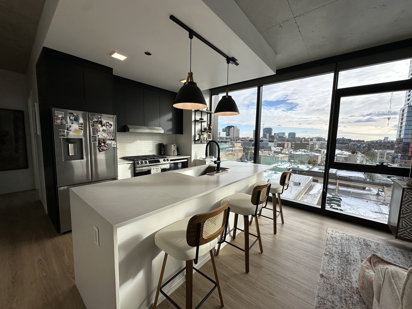 225 North Elizabeth Street, Unit 709 Chicago, IL 60607 - Photo 4 of 31 a kitchen with stainless steel appliances granite countertop a sink a stove and a refrigerator