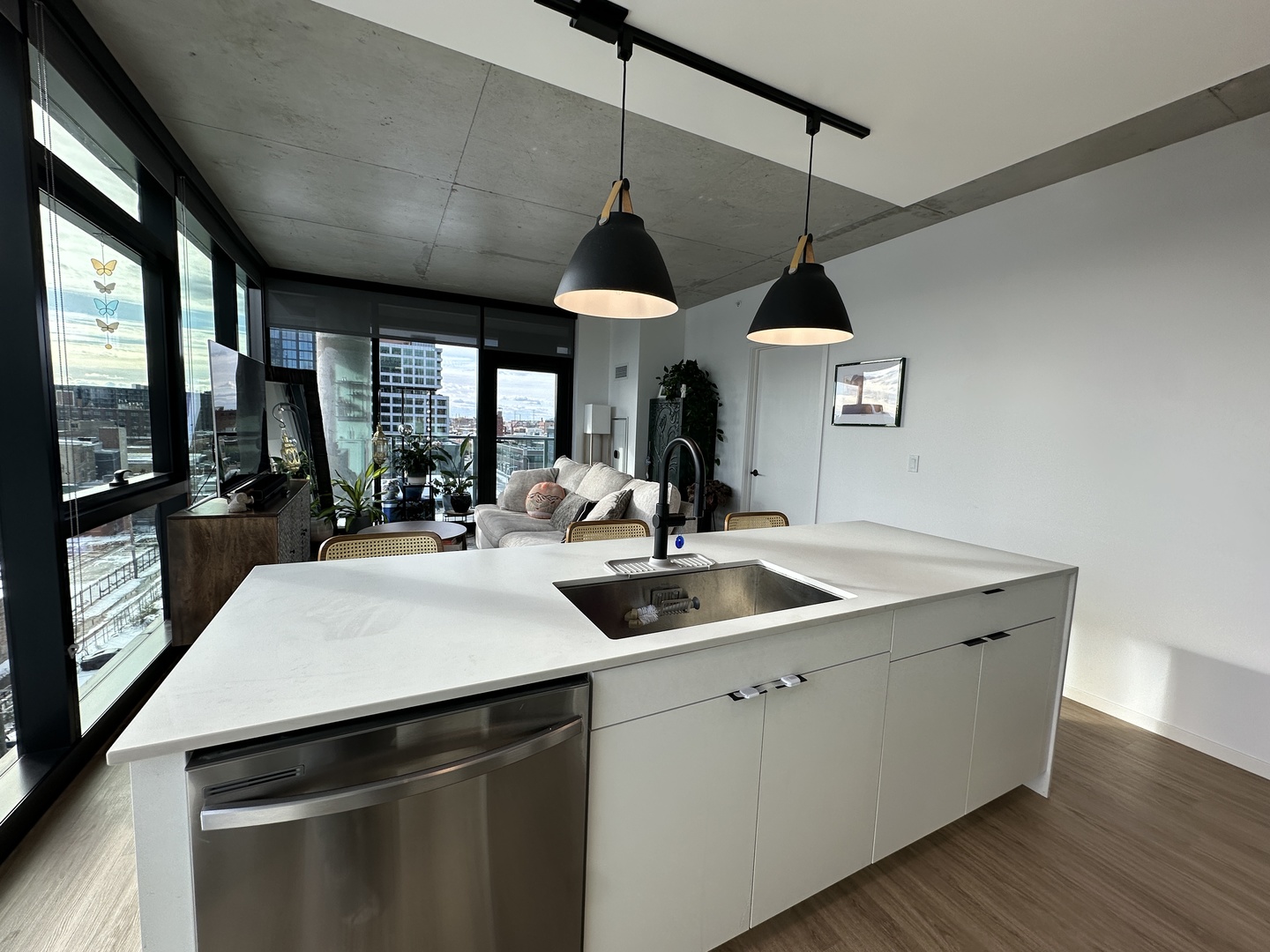 225 North Elizabeth Street, Unit 709 Chicago, IL 60607 - Photo 7 of 31 a kitchen with a sink a counter top space and a chandelier