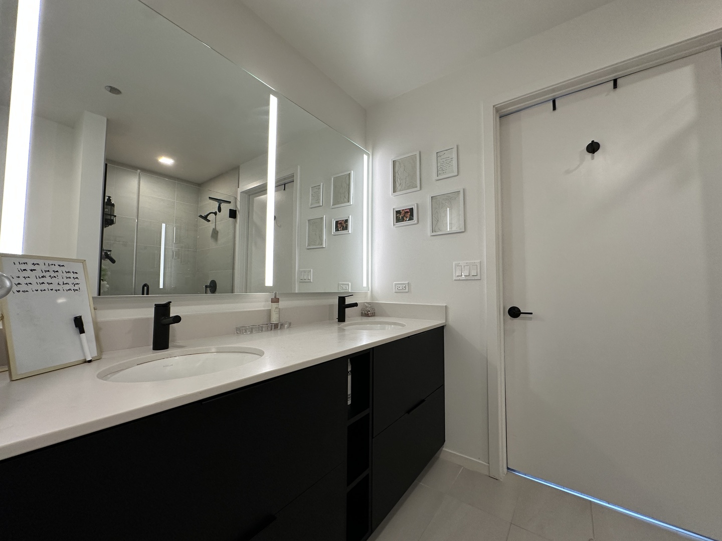 225 North Elizabeth Street, Unit 709 Chicago, IL 60607 - Photo 9 of 31 a bathroom with double sink and a mirror