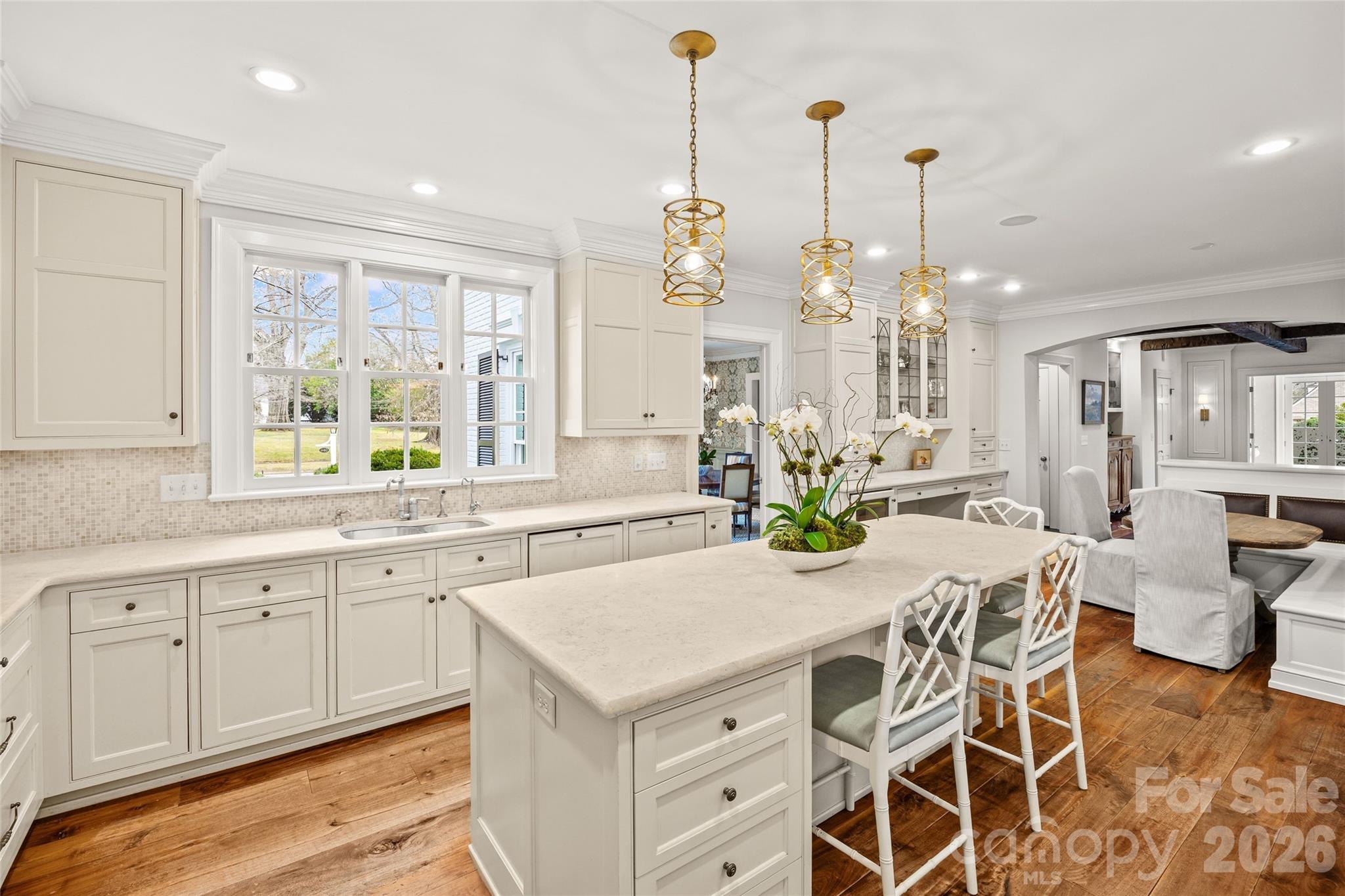 640 Colville Road Charlotte, NC 28207 - Photo 16 of 48 a view of a kitchen counter top space with granite countertop lots of wooden cabinets furniture and window