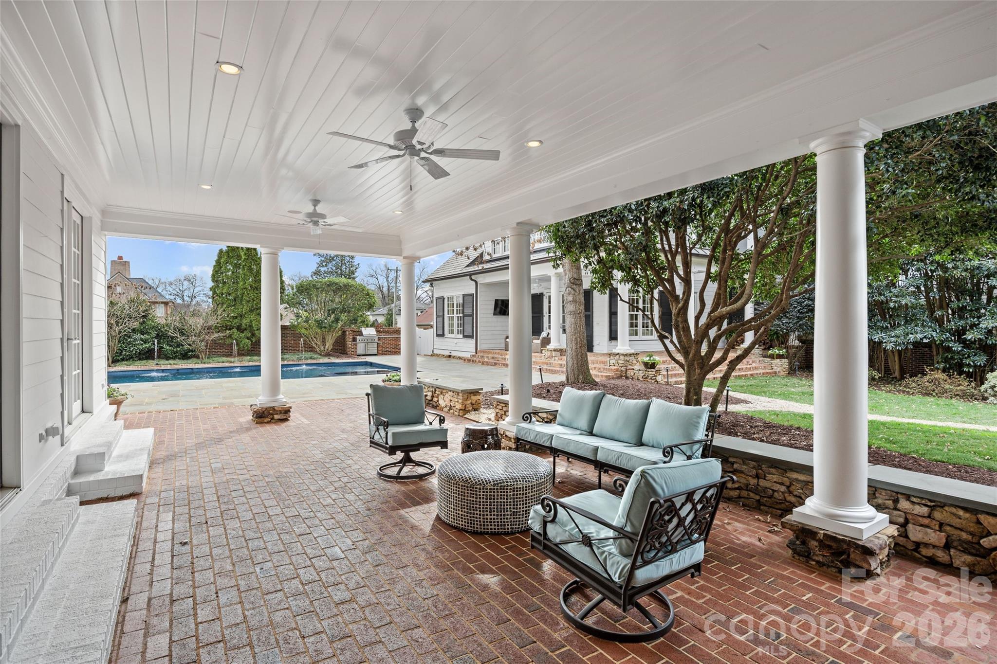 640 Colville Road Charlotte, NC 28207 - Photo 19 of 48 a living room with patio furniture and a floor to ceiling window