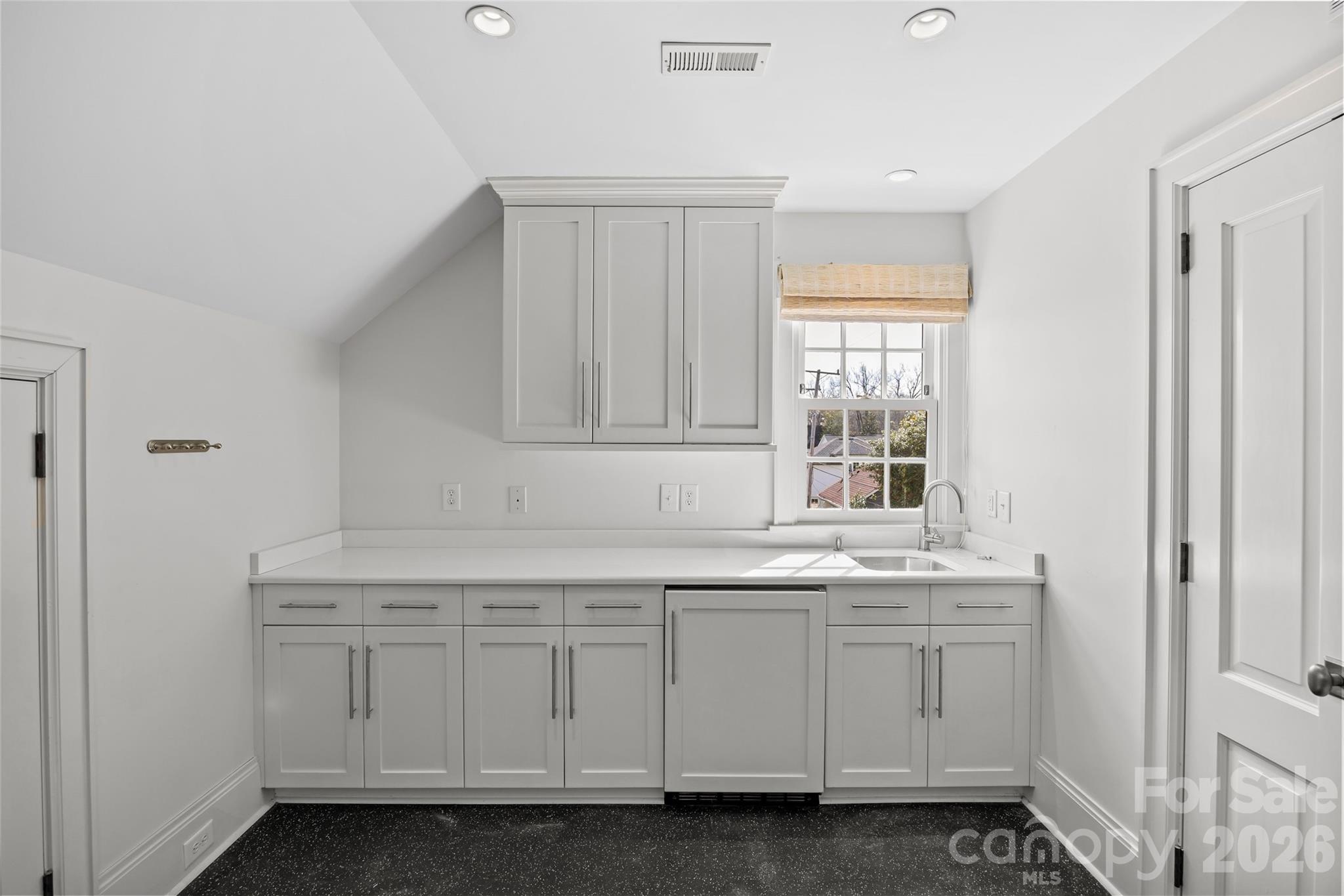 640 Colville Road Charlotte, NC 28207 - Photo 28 of 48 a kitchen with white cabinets and a sink