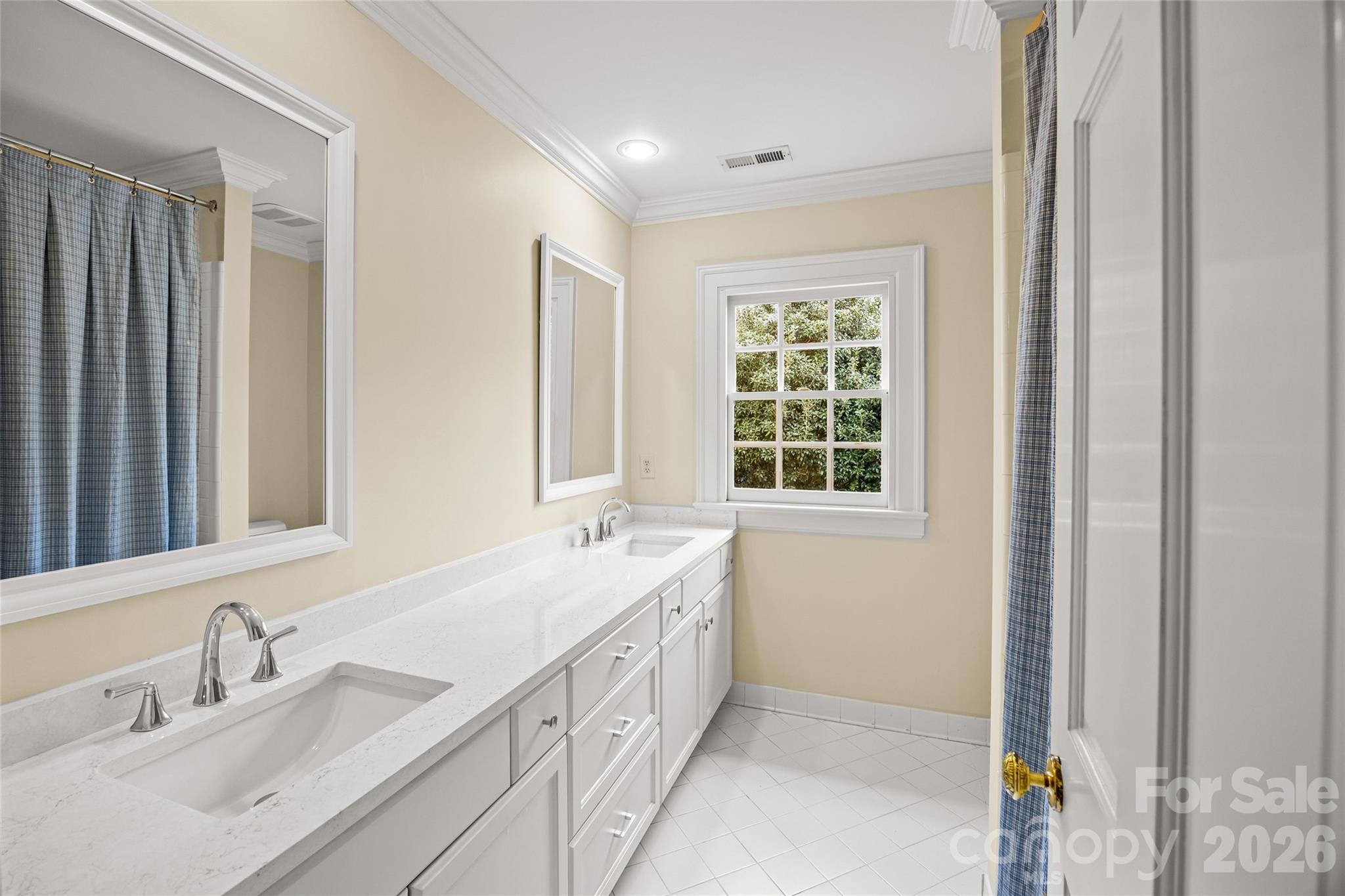 640 Colville Road Charlotte, NC 28207 - Photo 41 of 48 a bathroom with a double vanity sink and a mirror