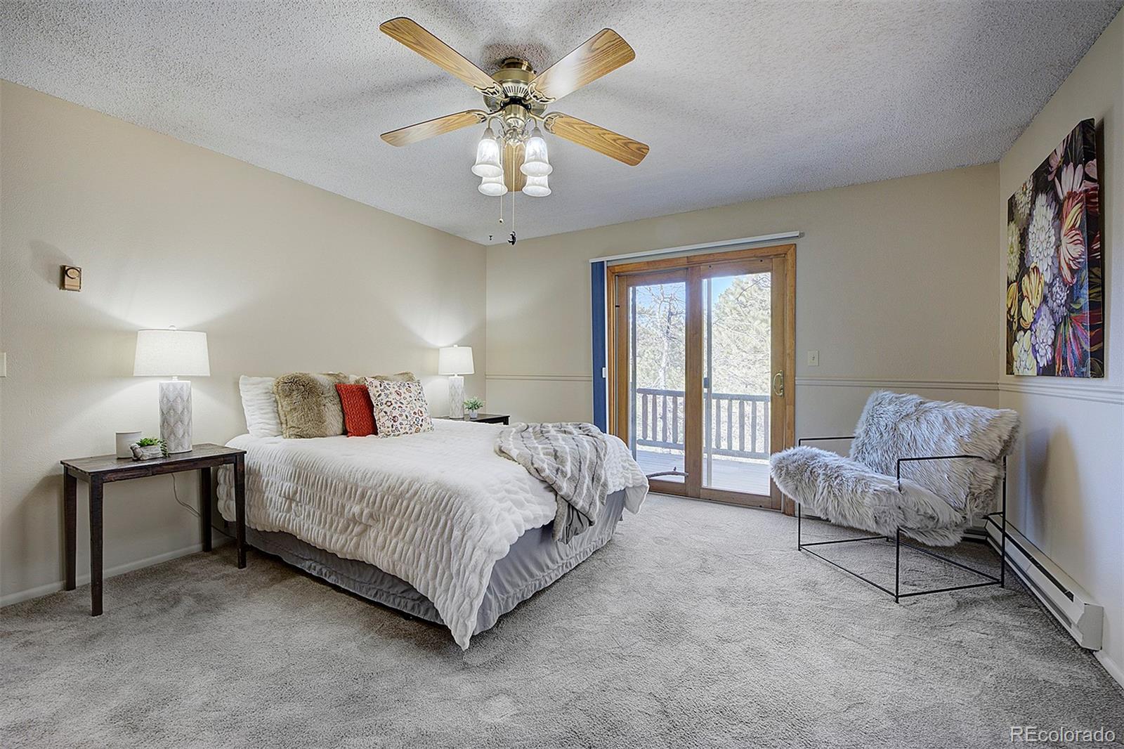 6561 Ridgeview Drive Morrison, CO 80465 - Photo 18 of 36 a bedroom with a bed and a chandelier