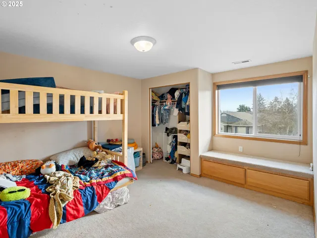 a bedroom with furniture and a window