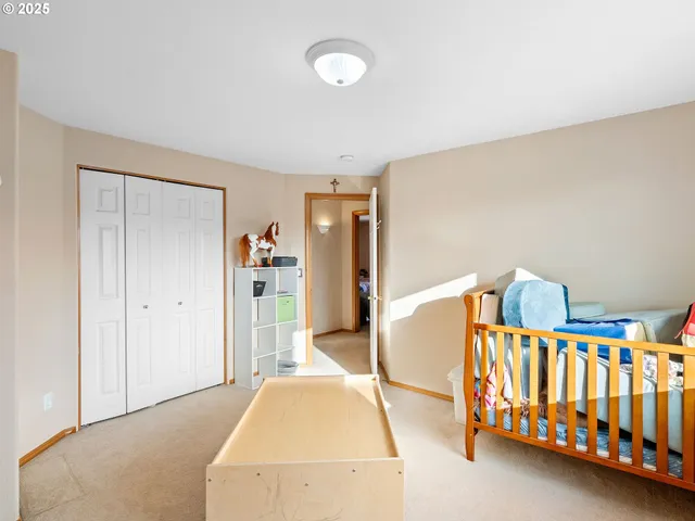 a bedroom with furniture and baby crib