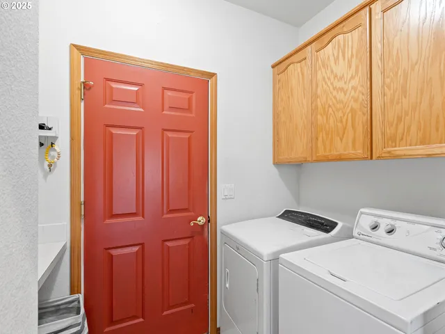 a view of storage and utility room with washer and dryer