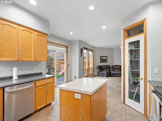 a kitchen with sink cabinets and refrigerator