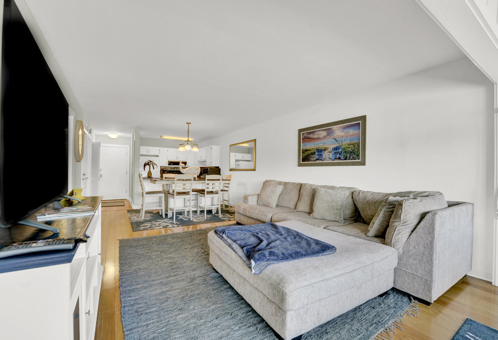 4725 Bay Point Road, Unit 261 Panama City Beach, FL 32408 - Photo 12 of 38 a living room with furniture and a flat screen tv