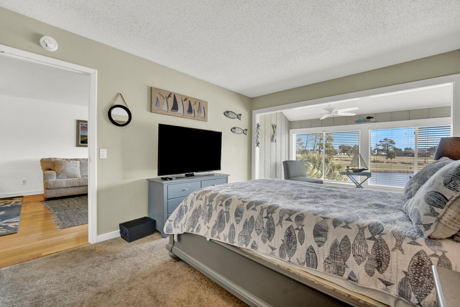 4725 Bay Point Road, Unit 261 Panama City Beach, FL 32408 - Photo 15 of 38 a bedroom with a bed and a flat tv screen on wall