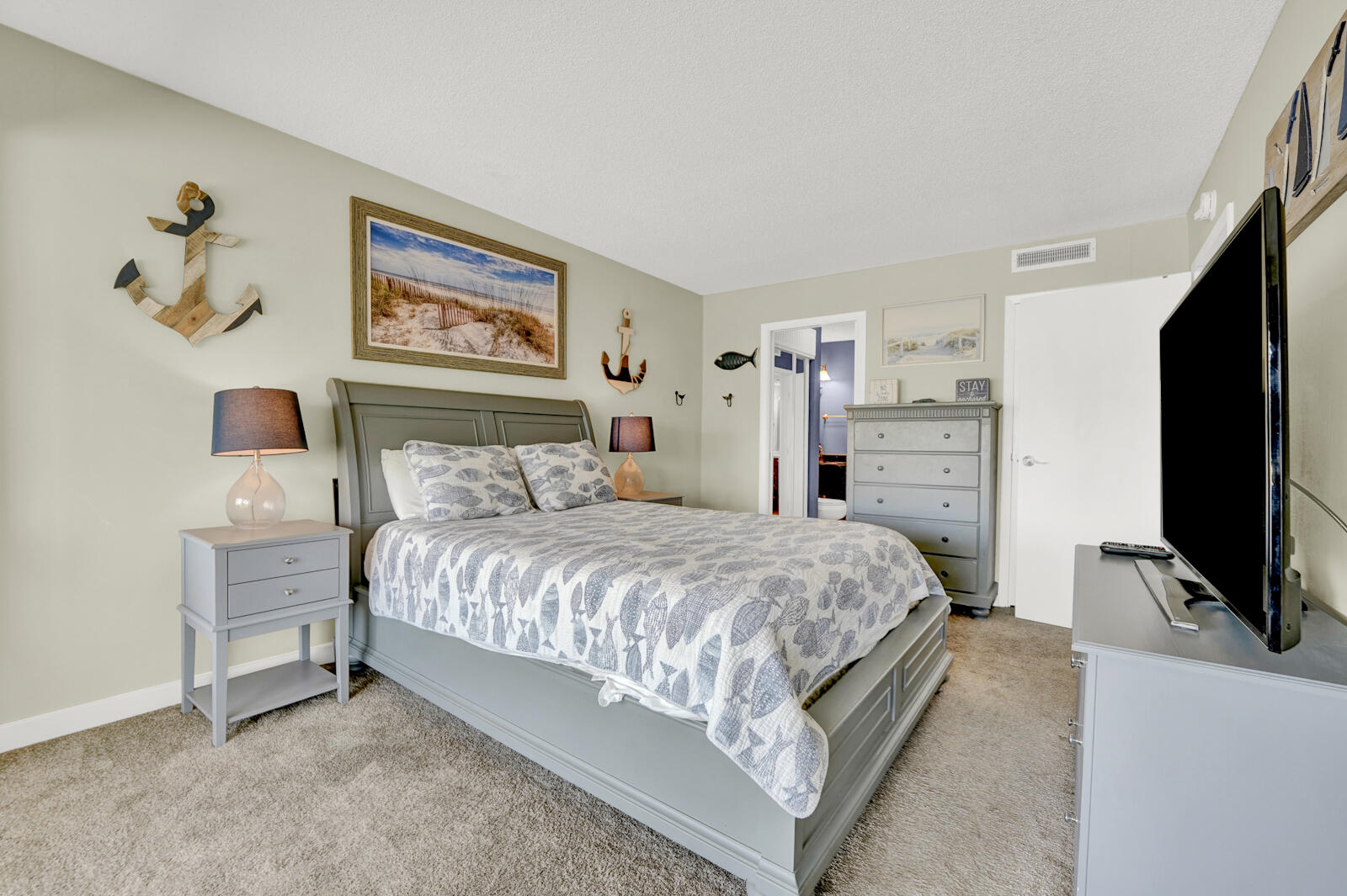 4725 Bay Point Road, Unit 261 Panama City Beach, FL 32408 - Photo 16 of 38 a bedroom with a bed and a flat screen tv