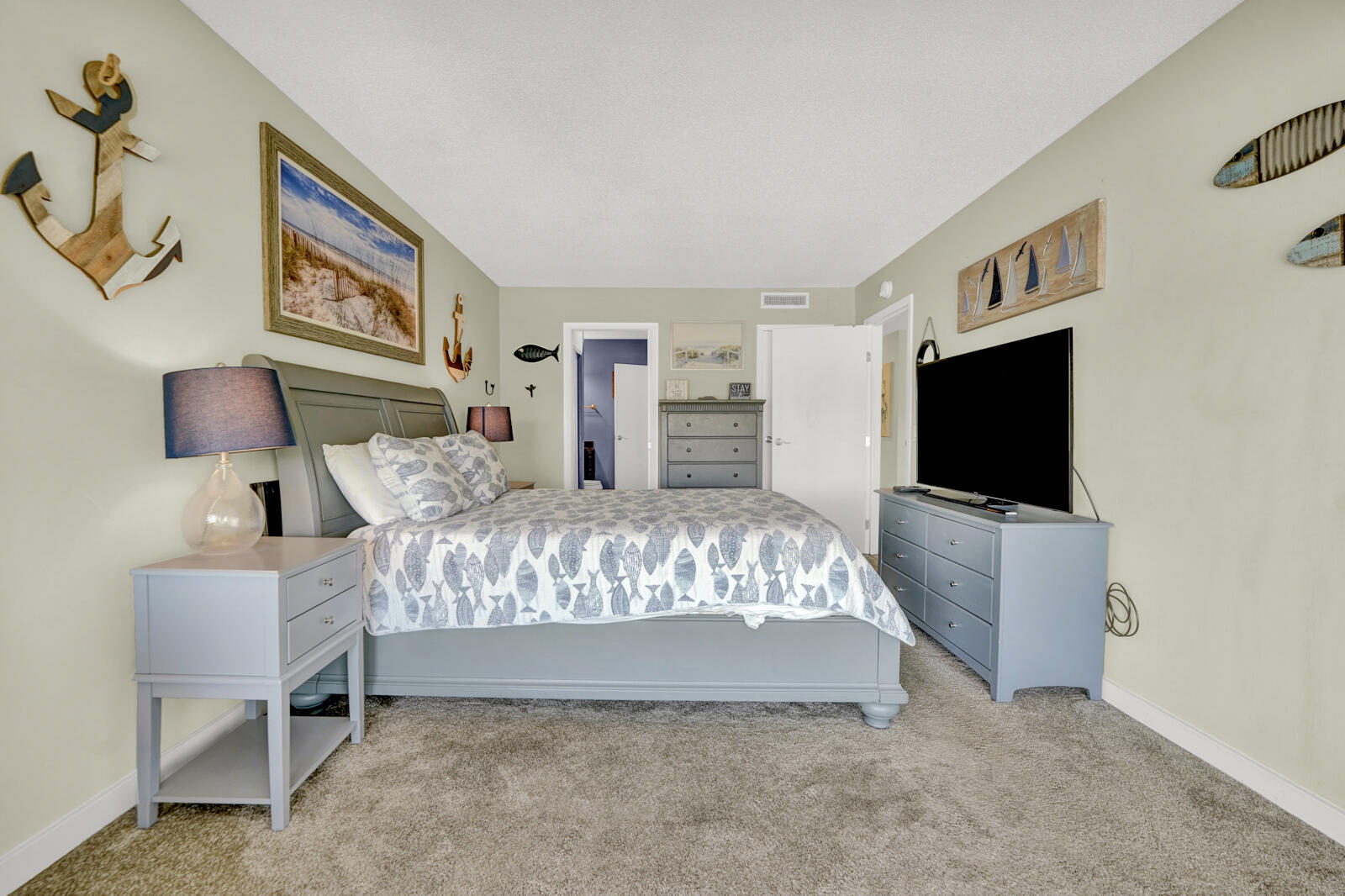 4725 Bay Point Road, Unit 261 Panama City Beach, FL 32408 - Photo 17 of 38 a bed room with furniture and a flat screen tv