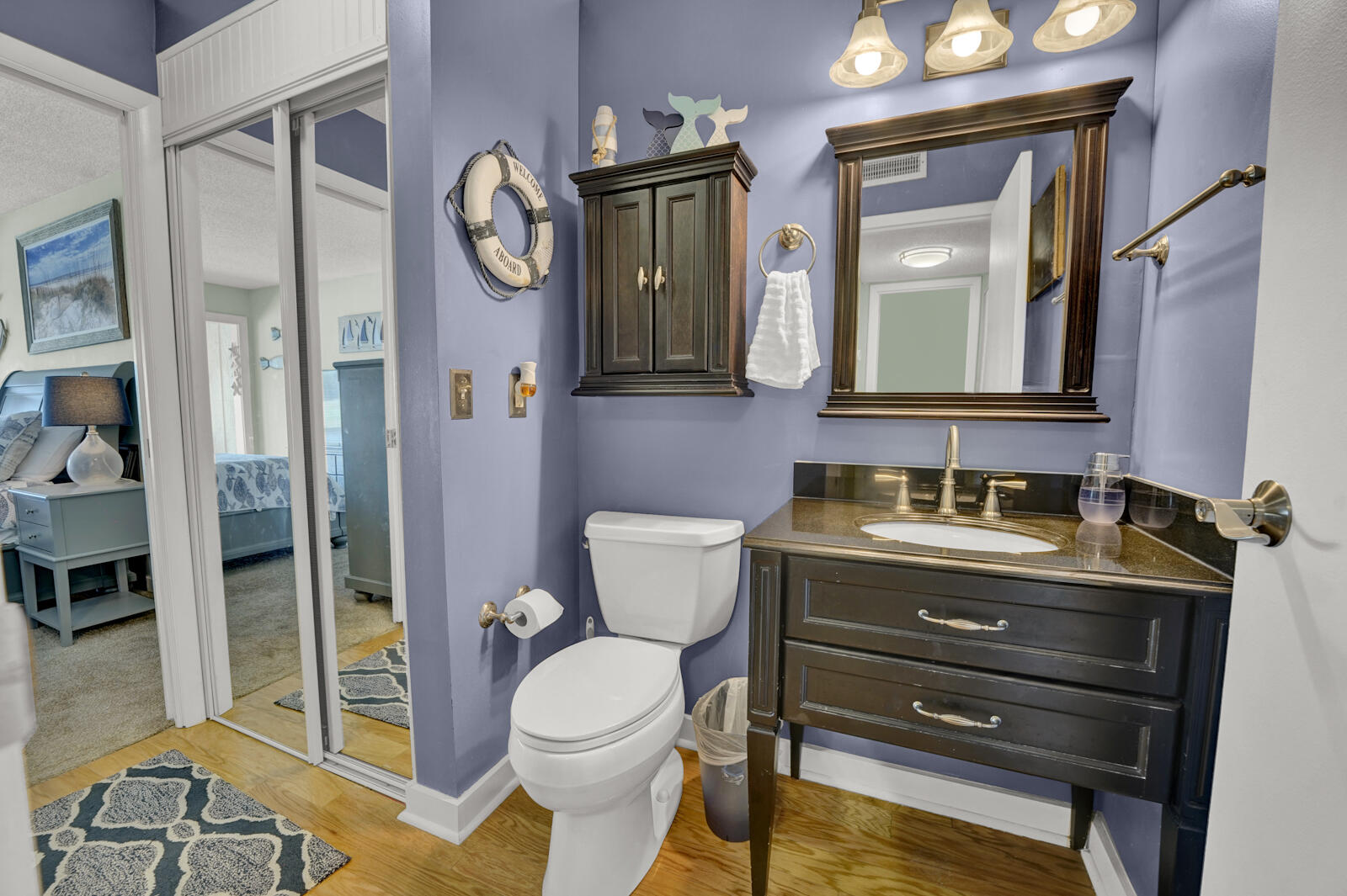 4725 Bay Point Road, Unit 261 Panama City Beach, FL 32408 - Photo 22 of 38 a bathroom with a toilet sink vanity and mirror