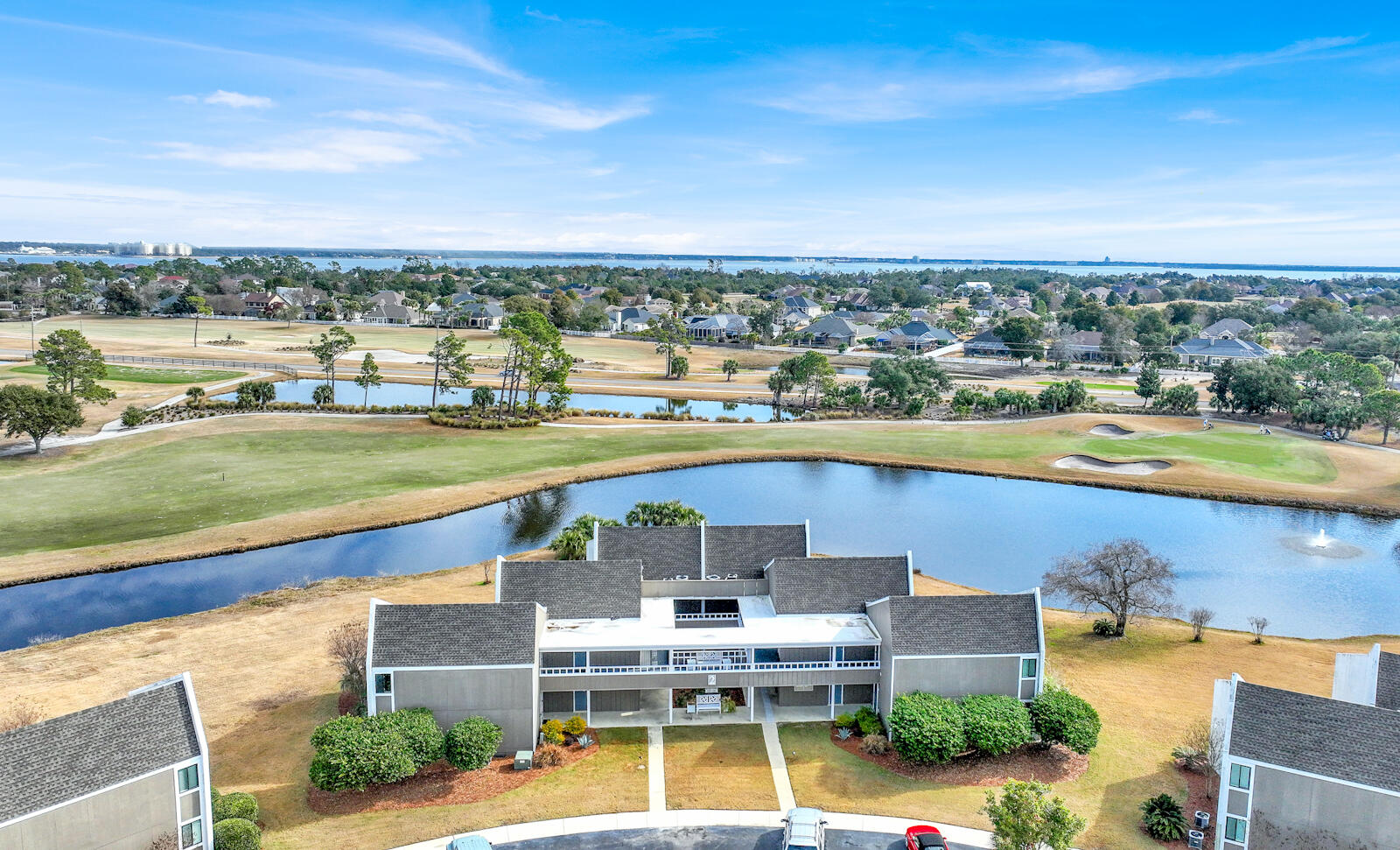 4725 Bay Point Road, Unit 261 Panama City Beach, FL 32408 - Photo 26 of 38 an aerial view of a house with swimming pool and lake view in back
