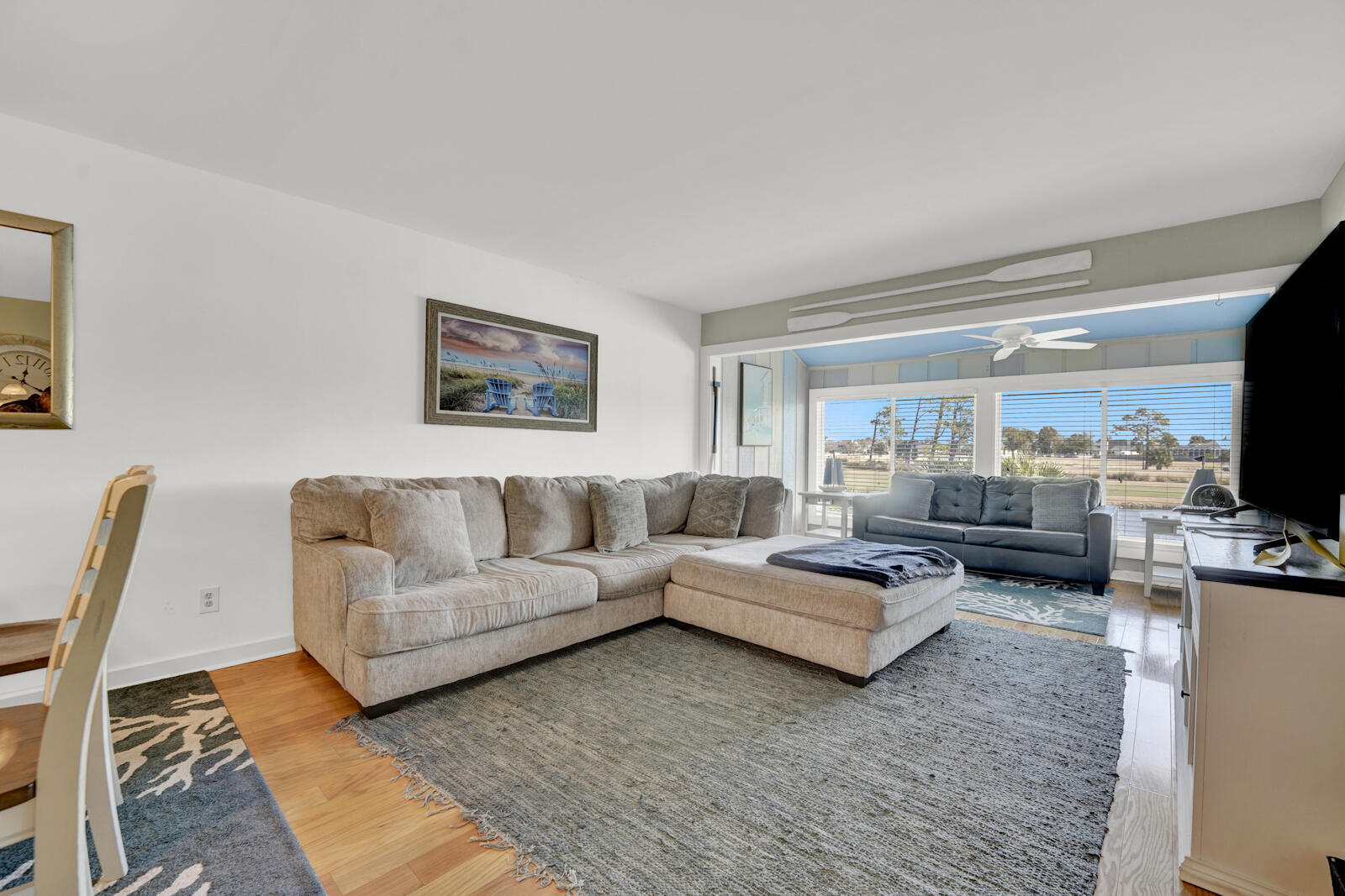 4725 Bay Point Road, Unit 261 Panama City Beach, FL 32408 - Photo 6 of 38 a living room with furniture and a flat screen tv