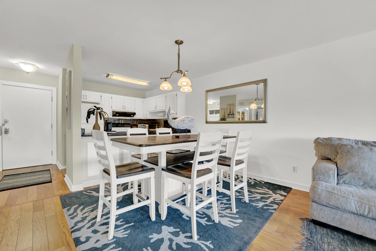 4725 Bay Point Road, Unit 261 Panama City Beach, FL 32408 - Photo 7 of 38 a view of a dining room with furniture and wooden floor
