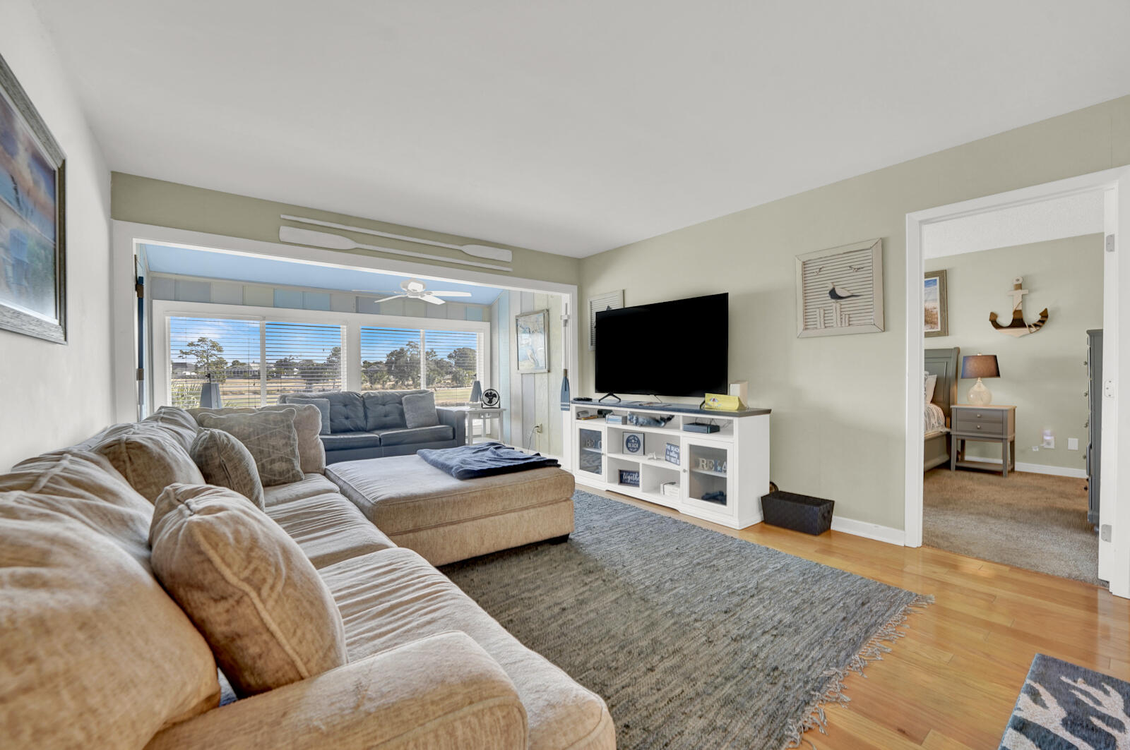 4725 Bay Point Road, Unit 261 Panama City Beach, FL 32408 - Photo 8 of 38 a living room with furniture and a flat screen tv