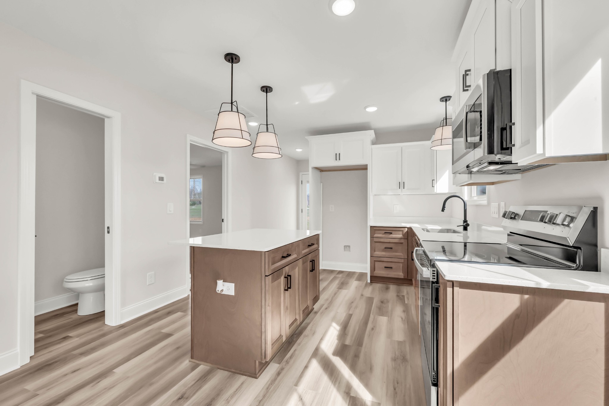 195 Quarry View Clarksville, TN 37043 - Photo 12 of 33 a kitchen with kitchen island granite countertop a sink cabinets and wooden floor
