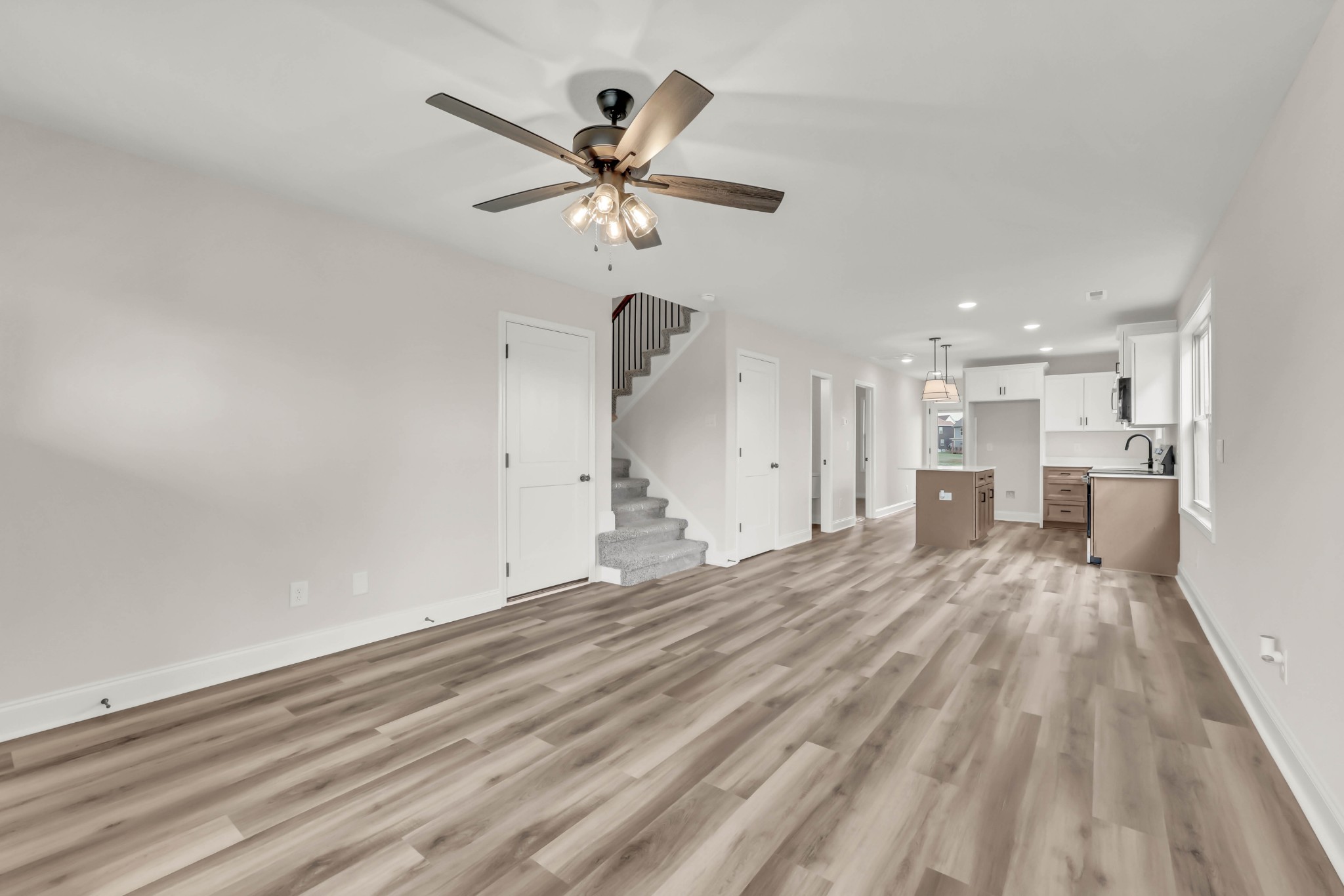 195 Quarry View Clarksville, TN 37043 - Photo 8 of 33 a view of a livingroom with a hardwood floor and a ceiling fan