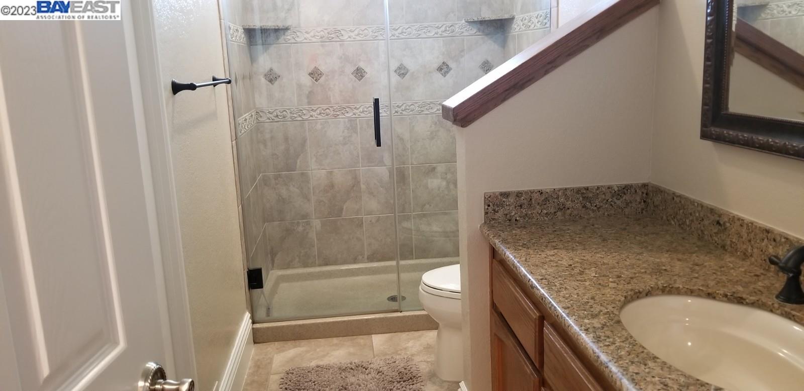 502 Regulus Road Livermore, CA 94550 - Photo 13 of 27 a bathroom with a granite countertop sink a toilet and shower