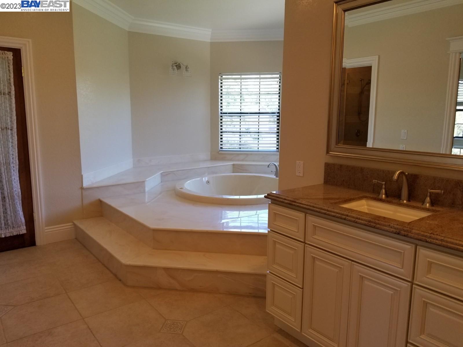 502 Regulus Road Livermore, CA 94550 - Photo 23 of 27 a bathroom with a granite countertop sink and mirror with bathtub