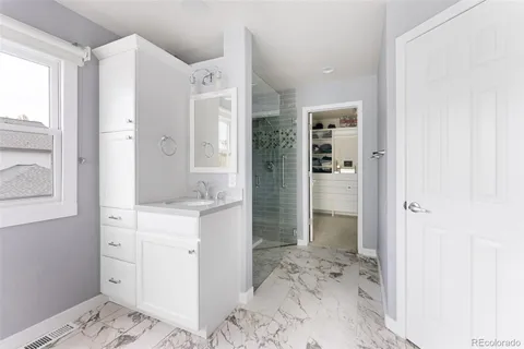 a view of walk in closet with clothes