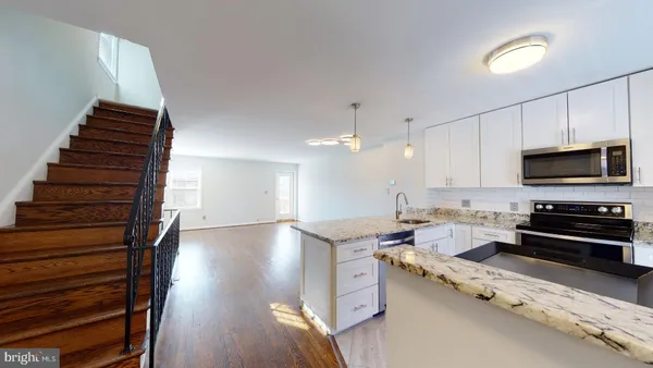 a kitchen with granite countertop a stove and a sink