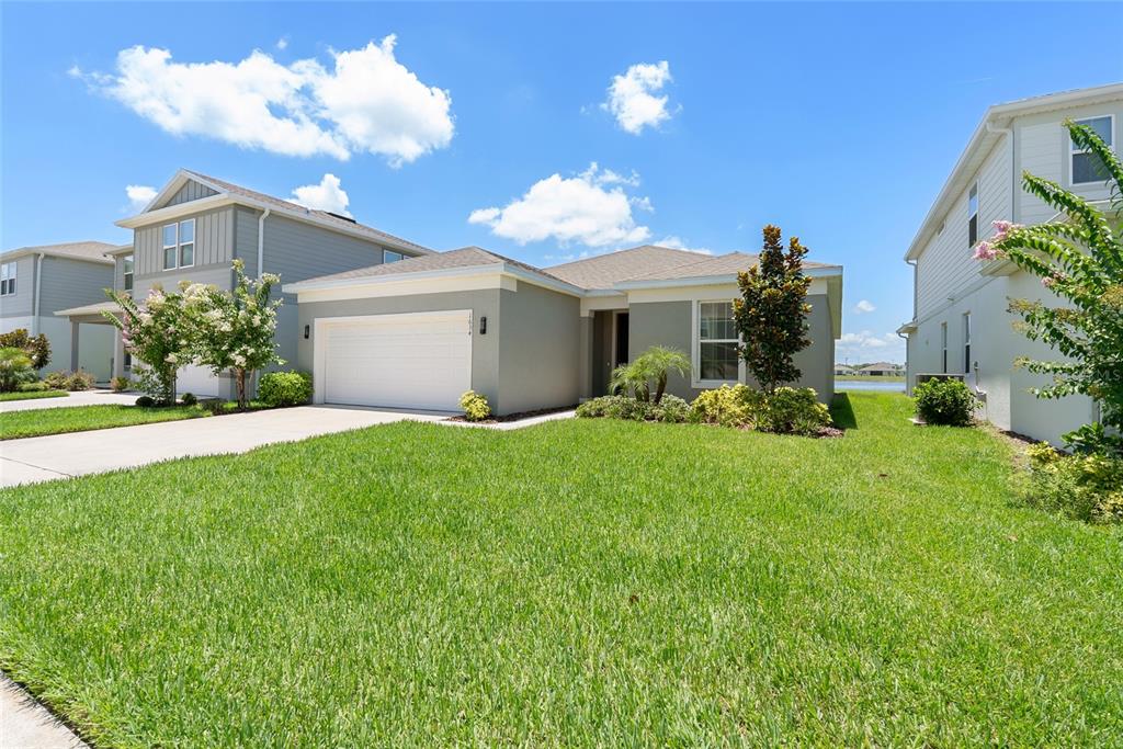 1634 Groveline Road St. Cloud, FL 34771 - Photo 42 of 43 a front view of a house with garden