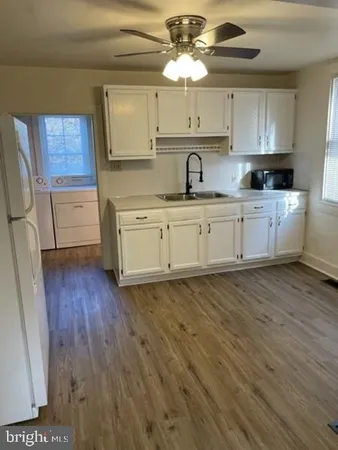 a kitchen with a sink window and cabinets