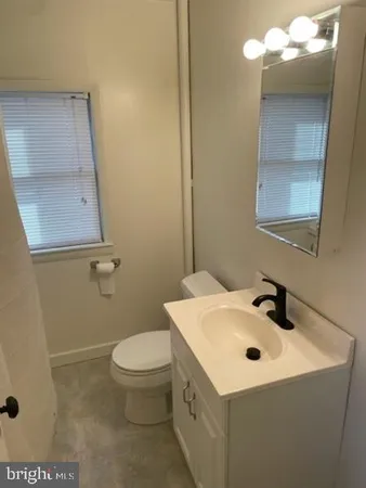 a bathroom with a sink a toilet and mirror