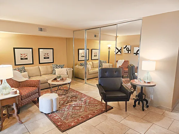 a living room with furniture and painting on the wall