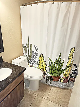 a large bed sitting in a bedroom next to a window