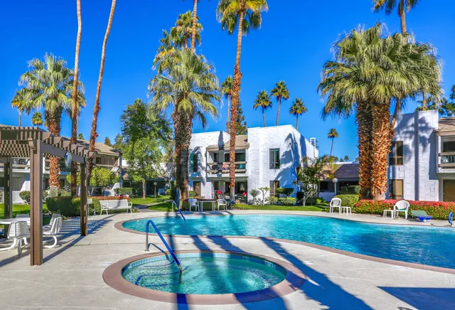 a bathroom with a granite countertop sink toilet and mirror