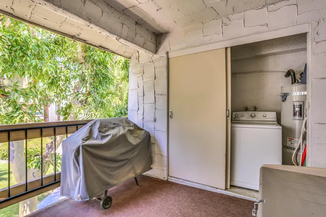 a view of a chair and tables in the balcony