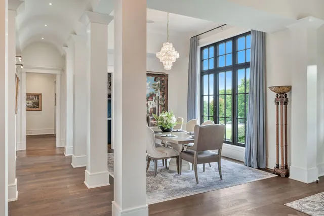 a living room with furniture a fireplace and a chandelier
