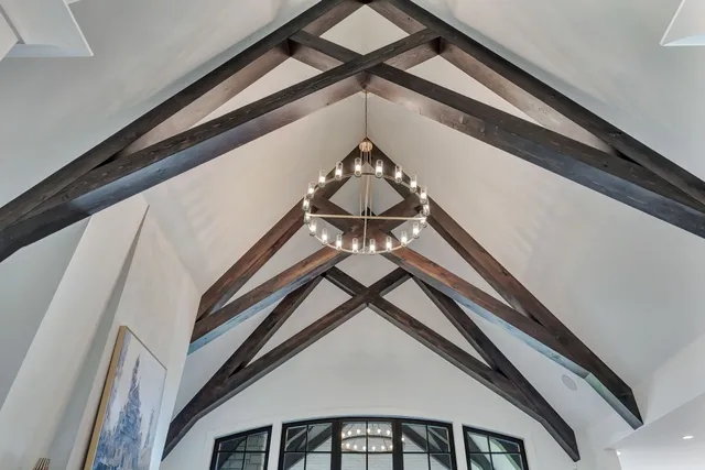 a large kitchen with kitchen island granite countertop a large center island a sink a stove and a wooden floors