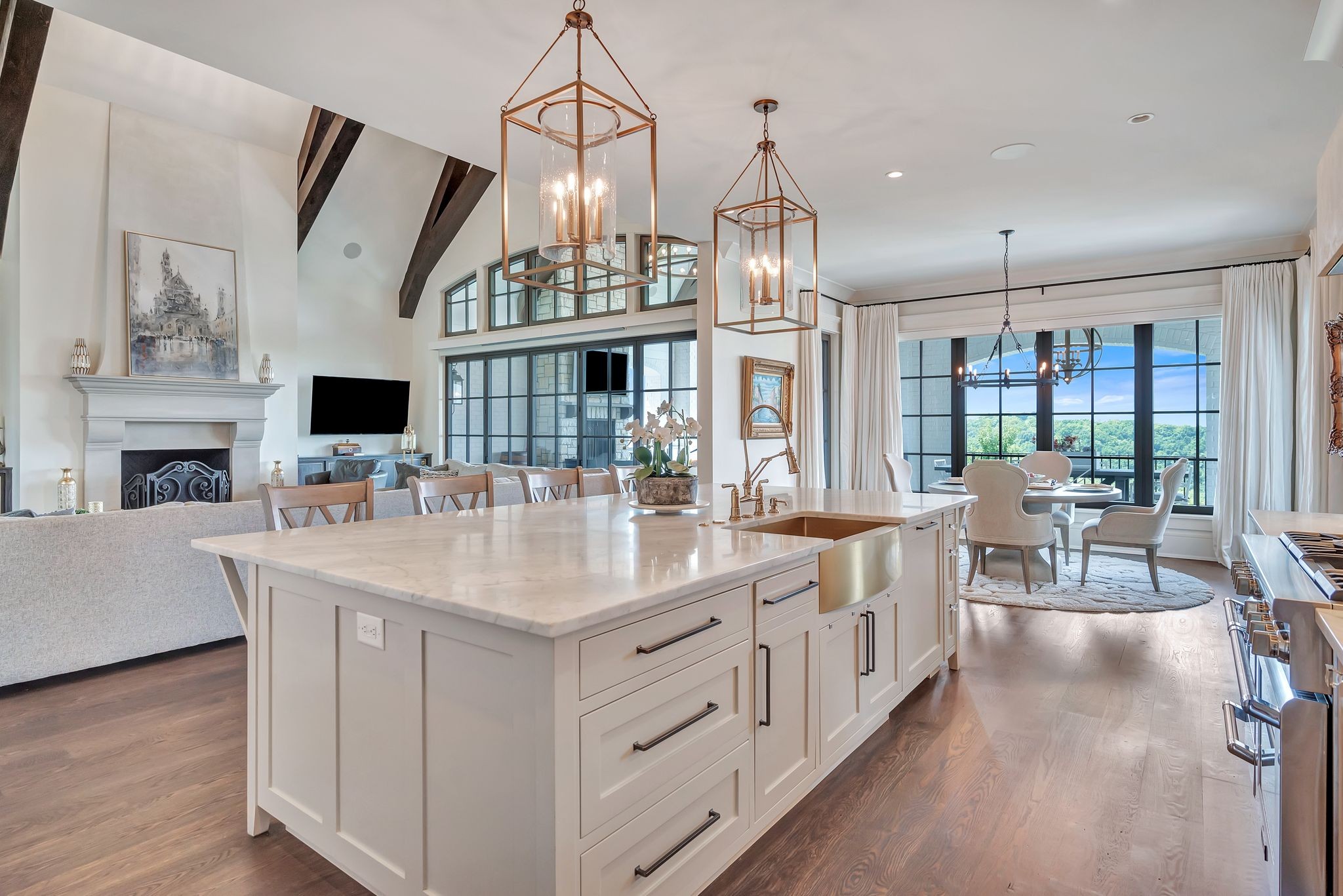 467 Canterbury Rise Franklin, TN 37067 - Photo 28 of 100 a large kitchen with kitchen island granite countertop a large center island a sink a stove and a wooden floors