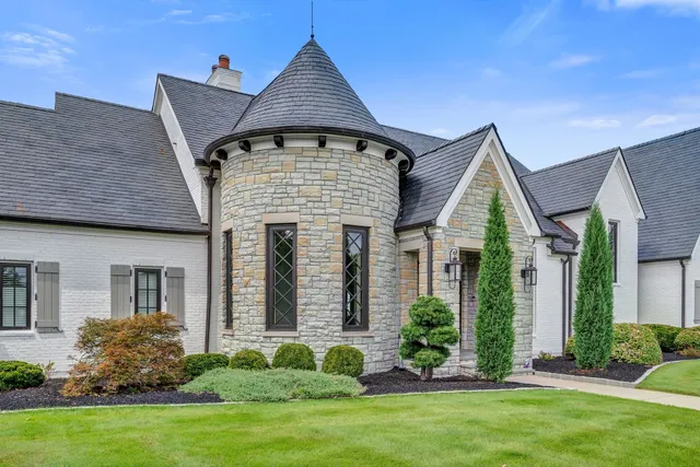 a view of a hallway with wooden floor and a dining room