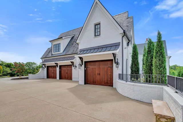 a dining room with wooden floor a chandelier a wooden table and chairs