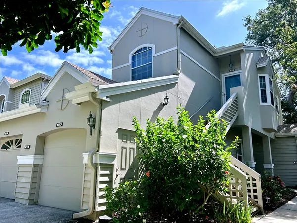 a large bedroom with a large bed and chandelier