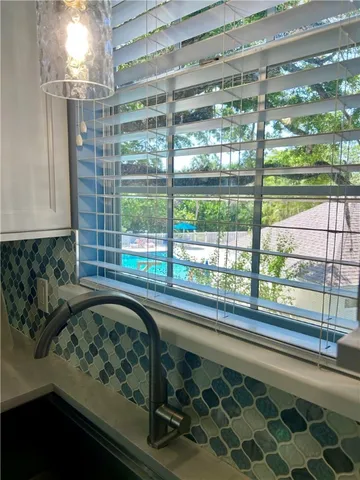 a kitchen with a sink and large window