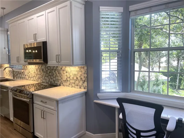 a kitchen with a stove a sink and a microwave