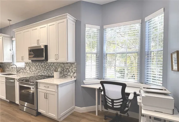 a kitchen that has a sink and a stove in it