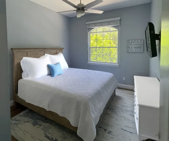 a bedroom with bed and window