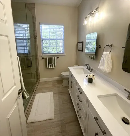 a bathroom with double vanity sink and mirror