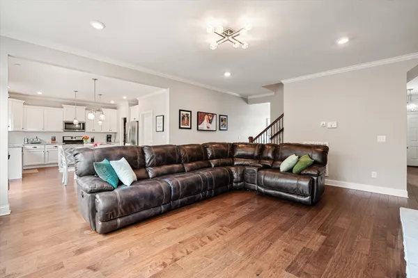 a living room with furniture and wooden floor